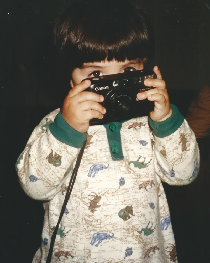 Thomas as a child holding his first camera, Puerto Varas, Chile, 2000